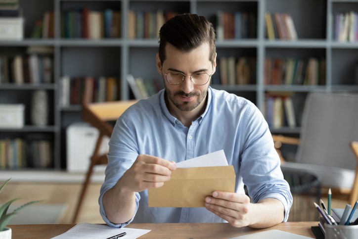 man reading direct mail